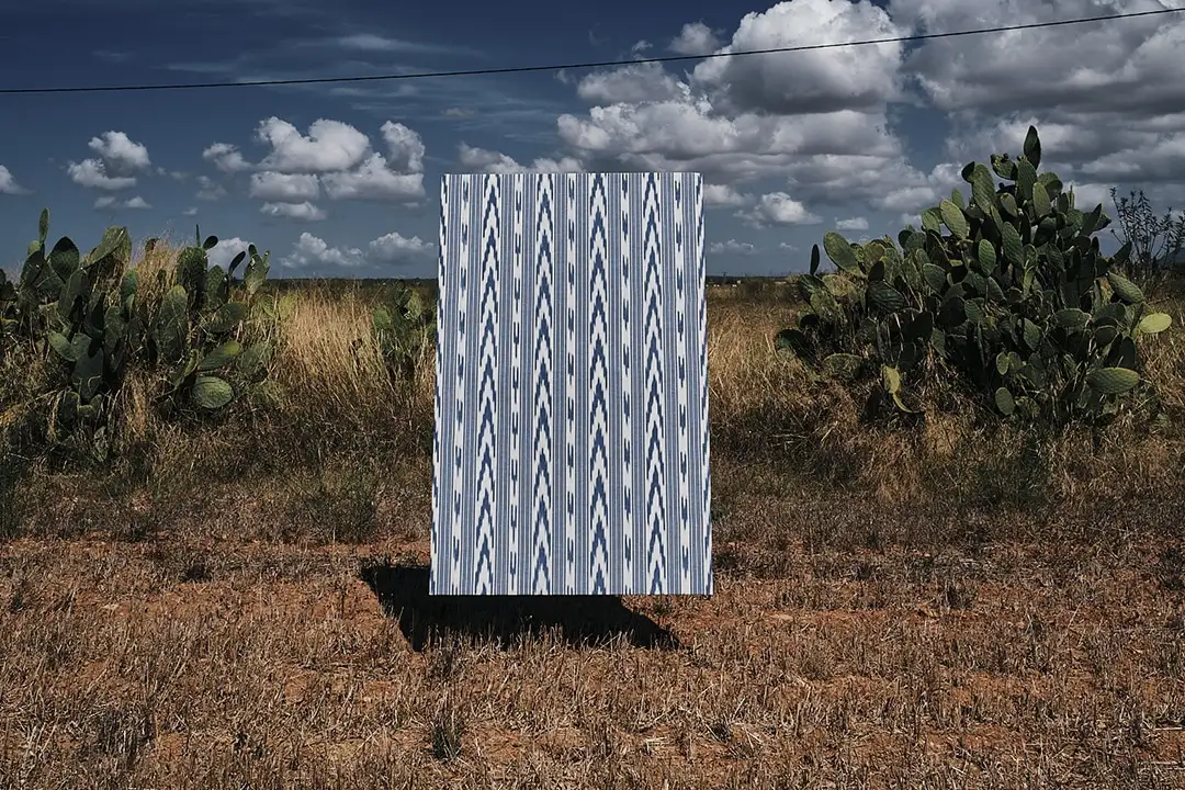 Blue and white Mallorcan ikat by Teixits Riera hung outdoors